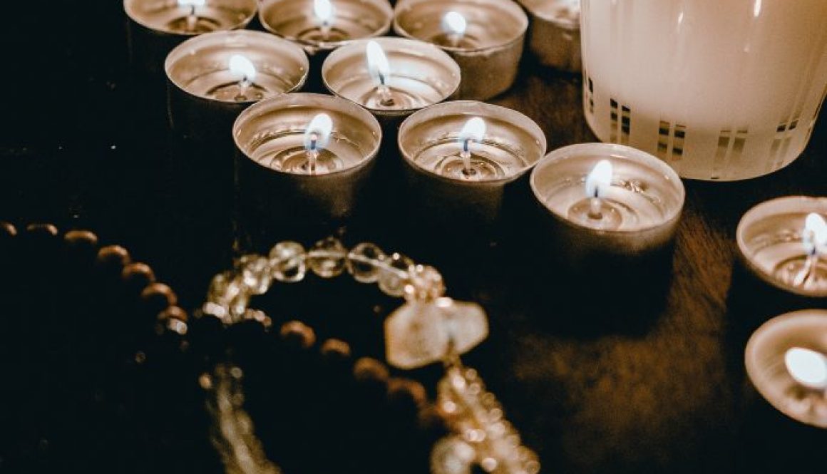 candle-lights-and-necklace-on-wooden-table-4083122