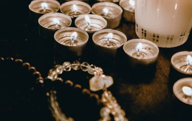 candle-lights-and-necklace-on-wooden-table-4083122
