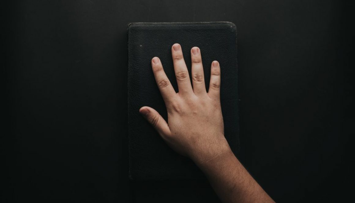 man-touching-book-2258252