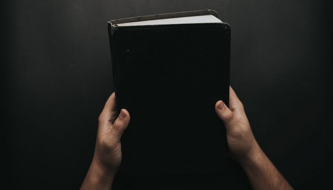 person-holding-black-cover-bible-2258240