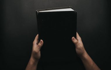 person-holding-black-cover-bible-2258240