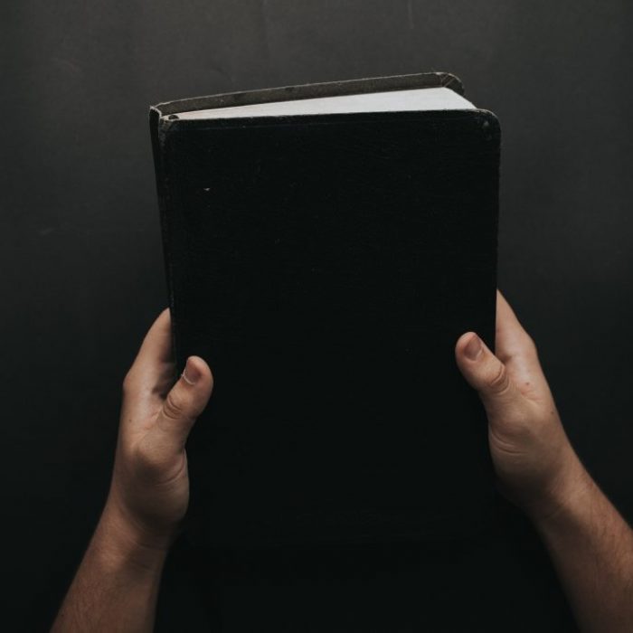 person-holding-black-cover-bible-2258240