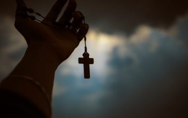 person-holding-brown-wooden-cross-4068583
