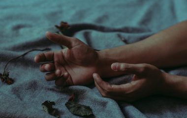 person-lying-on-gray-textile-917481